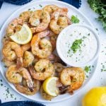Air fryer shrimp is served with a dipping sauce.