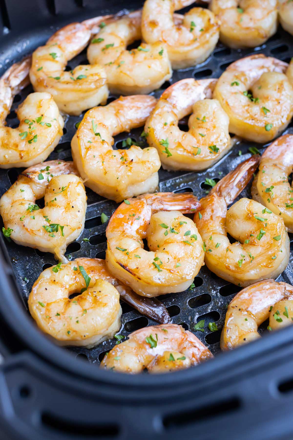 Season shrimp with lemon and parsley after air frying.