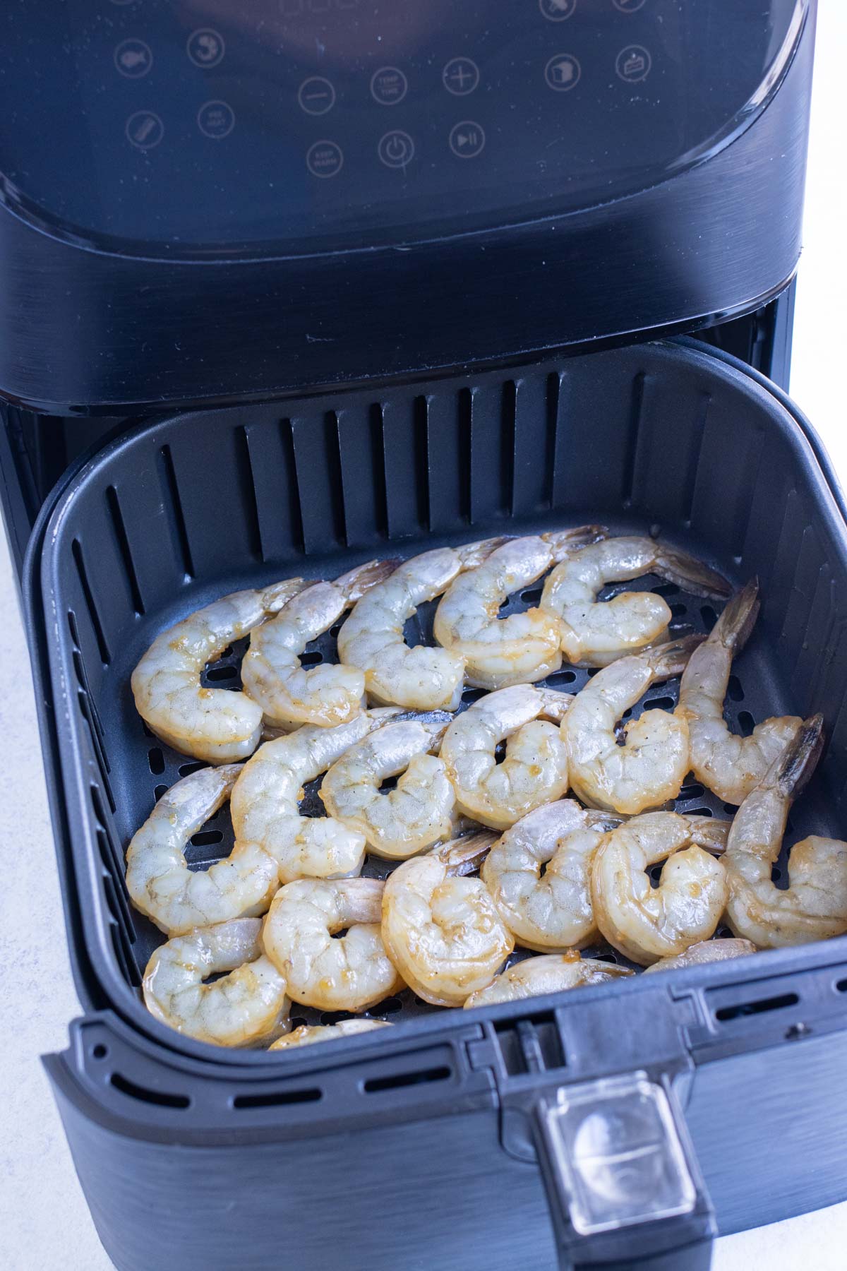 Shrimp is air fried in a single layer.