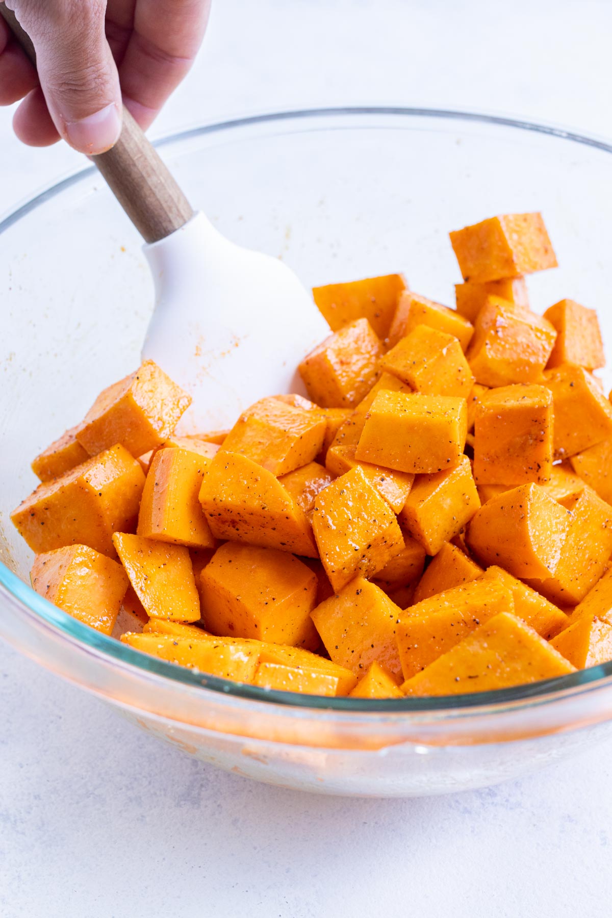 A spatula stirs healthy sweet potatoes.