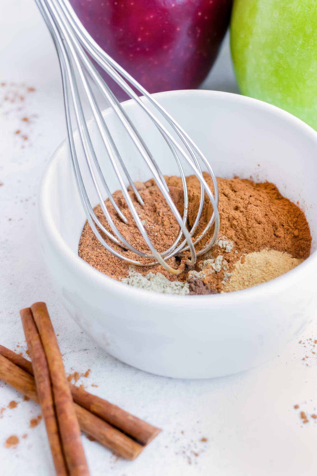 Use a whisk to completely blend together cinnamon, nutmeg, ginger, cardamom, and all spice.