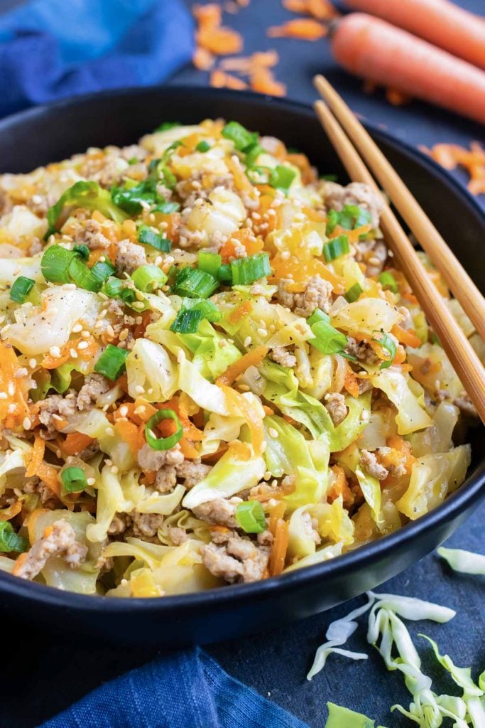 An easy and healthy keto egg roll in a bowl recipe that is made of ground turkey or beef, cabbage, carrots, and Asian flavors.