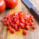 A sharp knife is used to dice tomatoes easily.