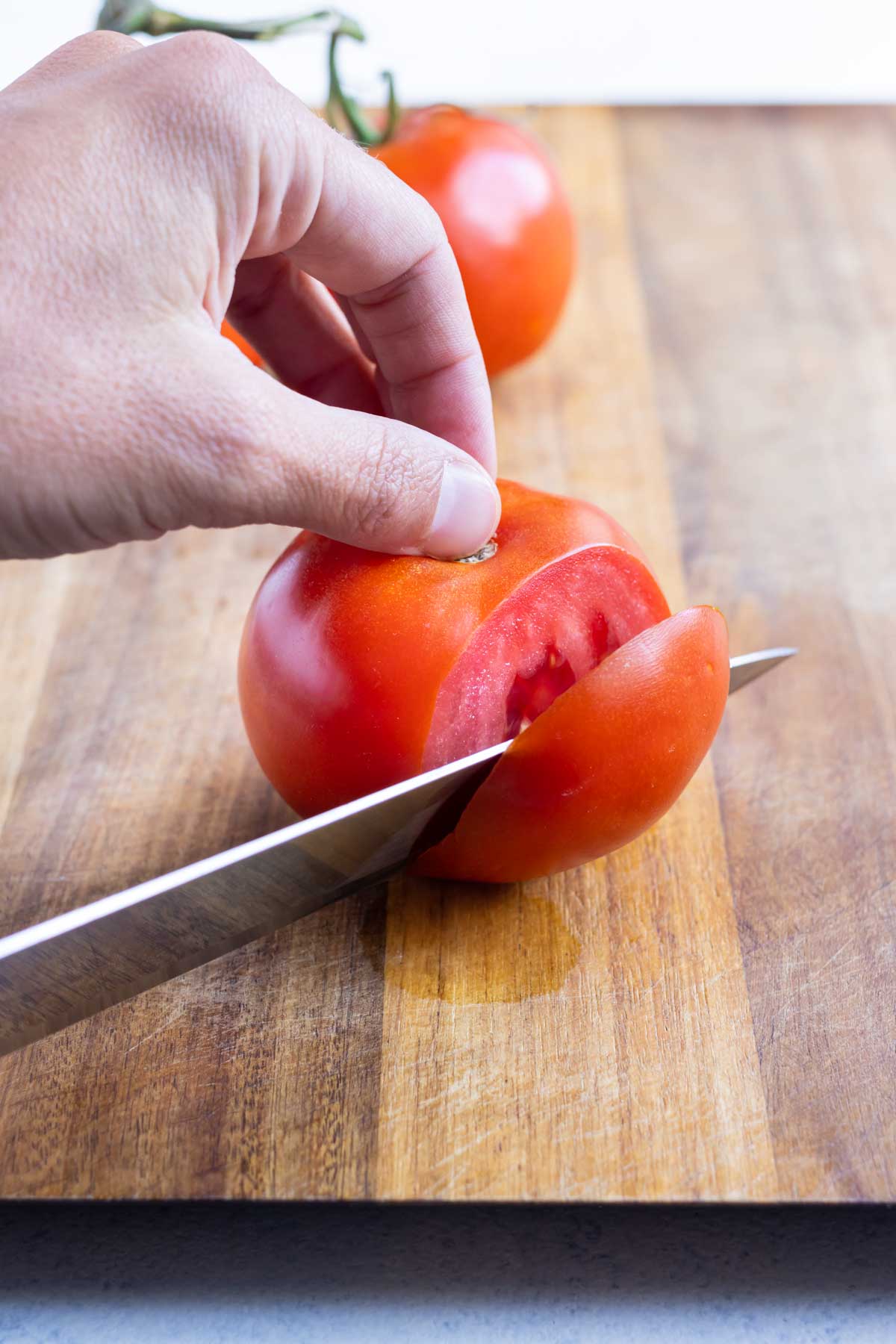 A wedge is cut away from the tomato core.