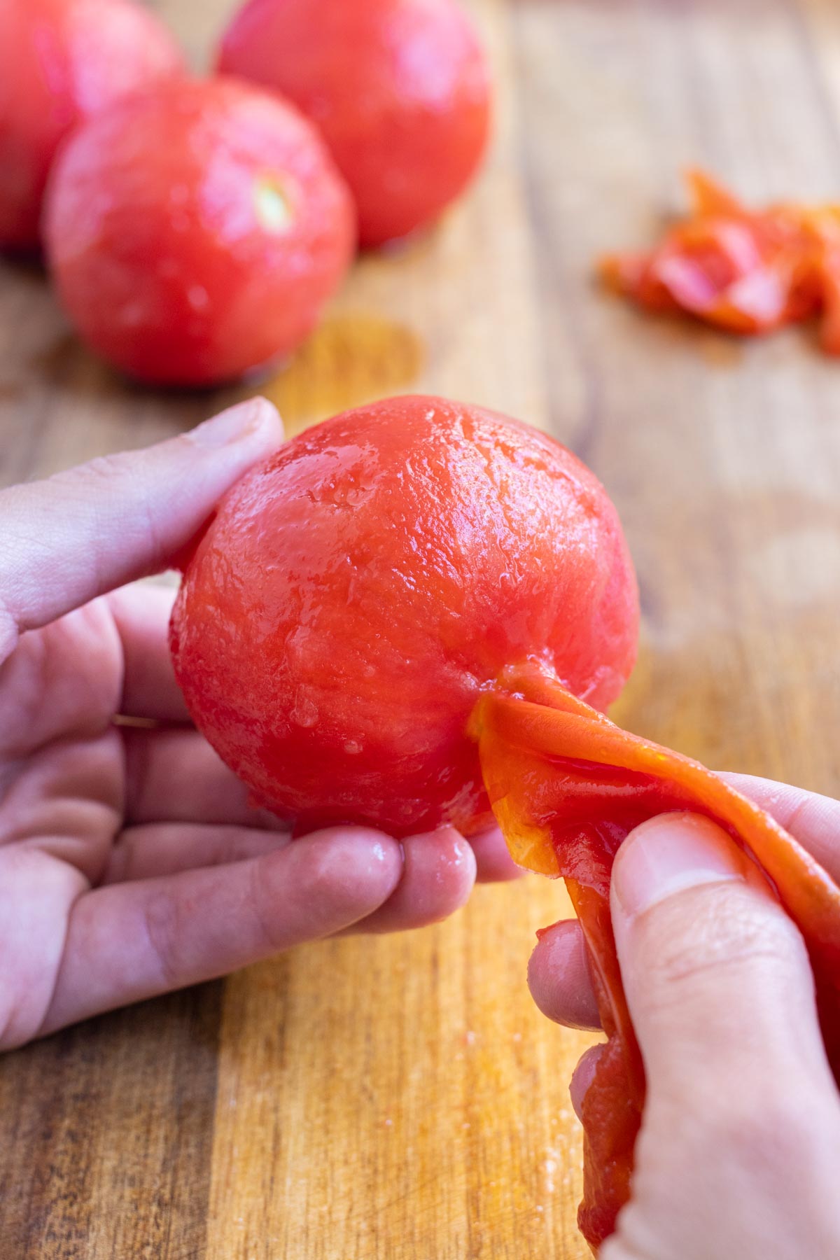 The skin should come off a tomato easily after bar-boiling it.