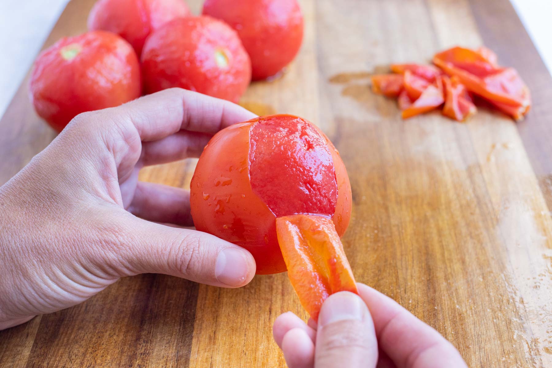 It is simple to carefully remove the skin of a tomato after par-boiling.