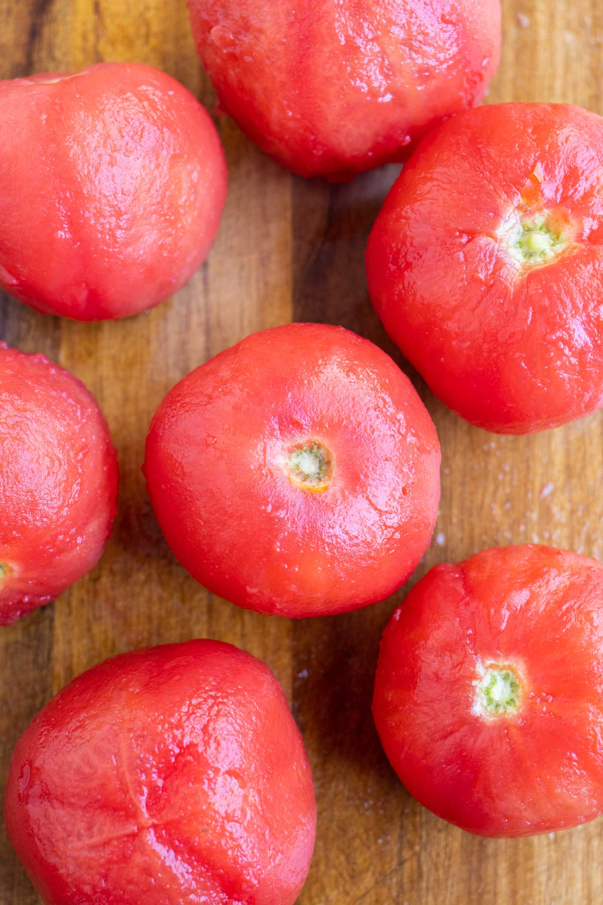 Easily peeled tomatoes on a cutting board.