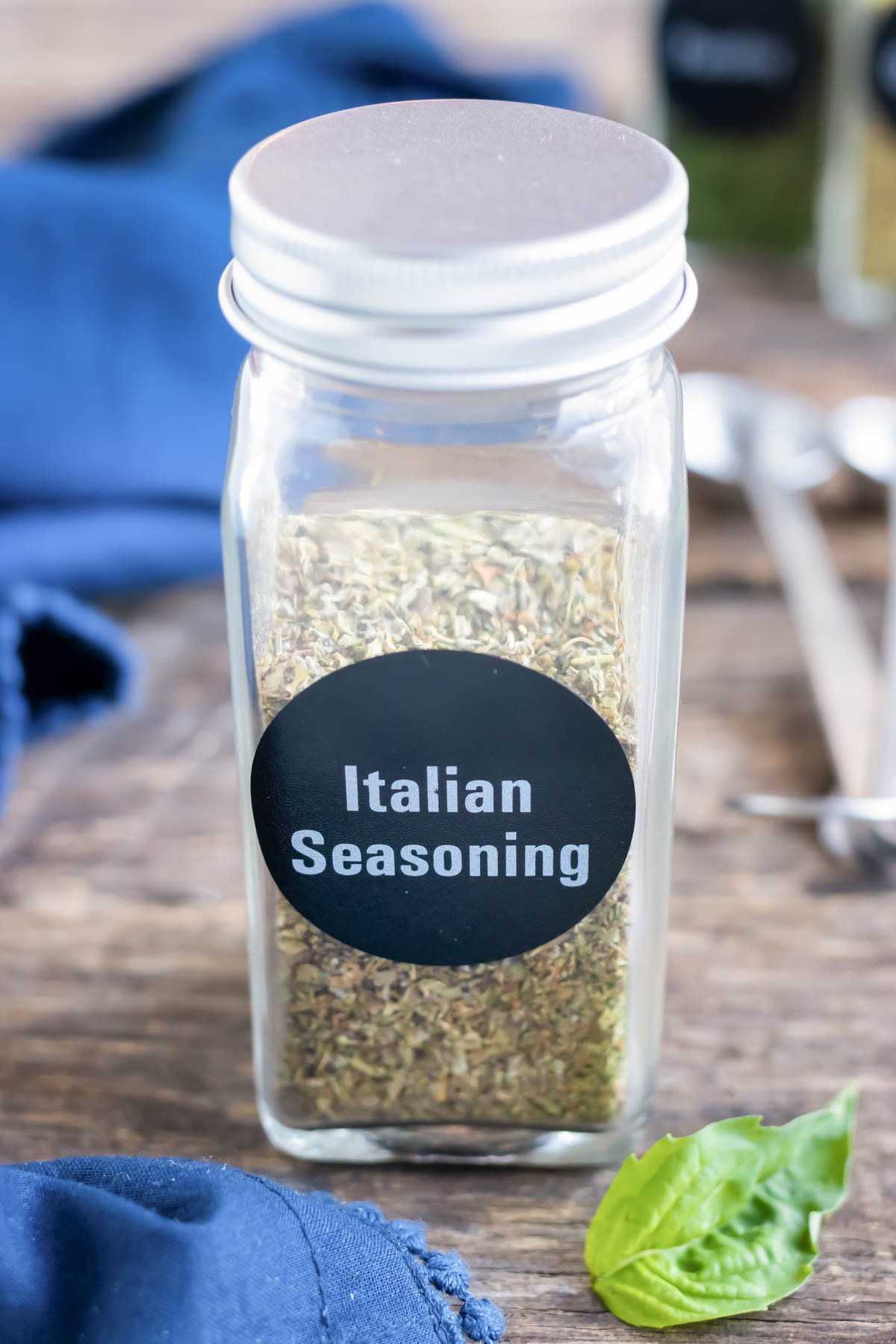 Homemade Italian seasoning mix in a glass jar for storage.