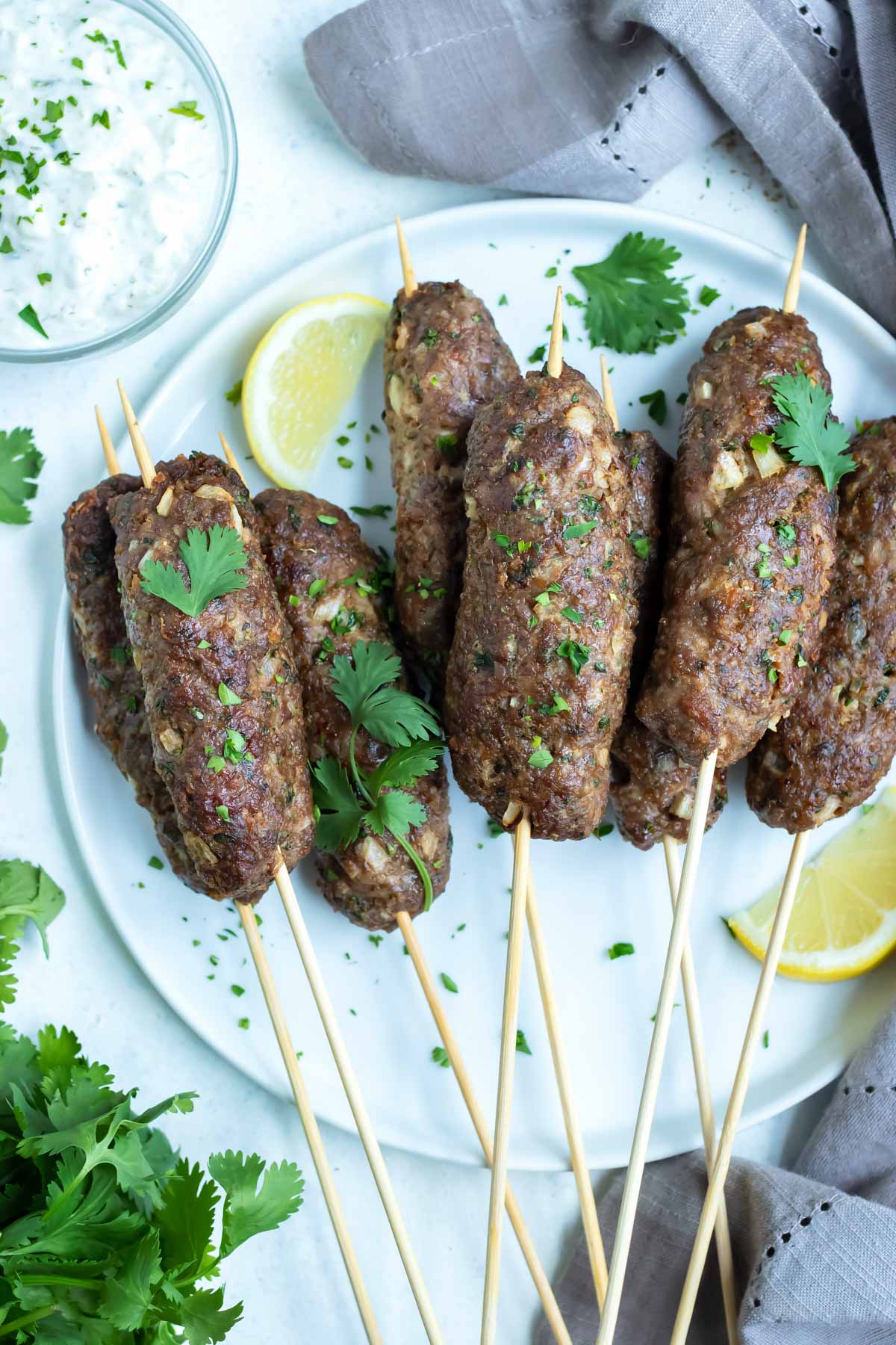 A plate of Lamb Kofta is set on the counter for a Greek inspired meal.