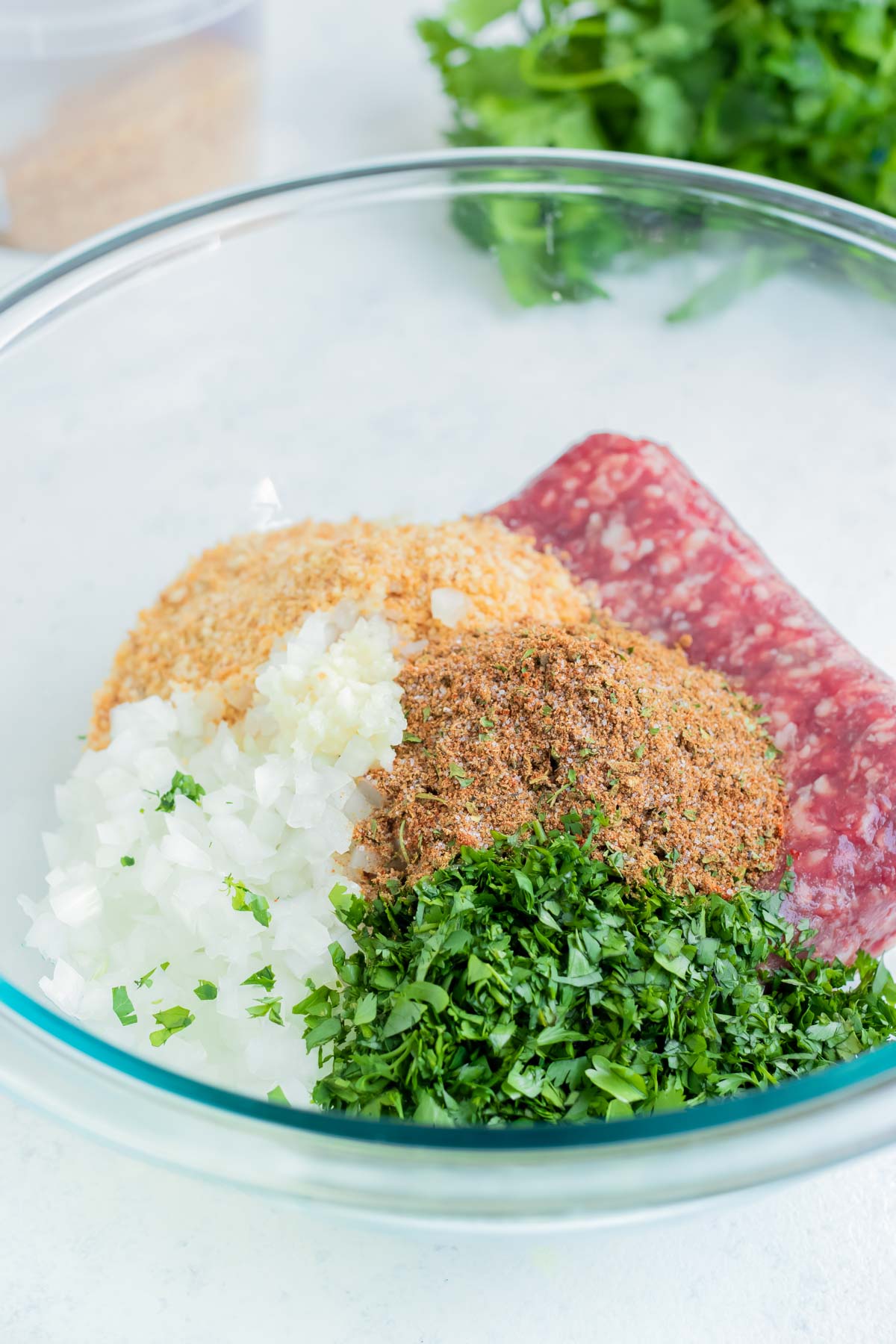 All the ingredients are combined in a glass bowl for these Lamb Kebabs.