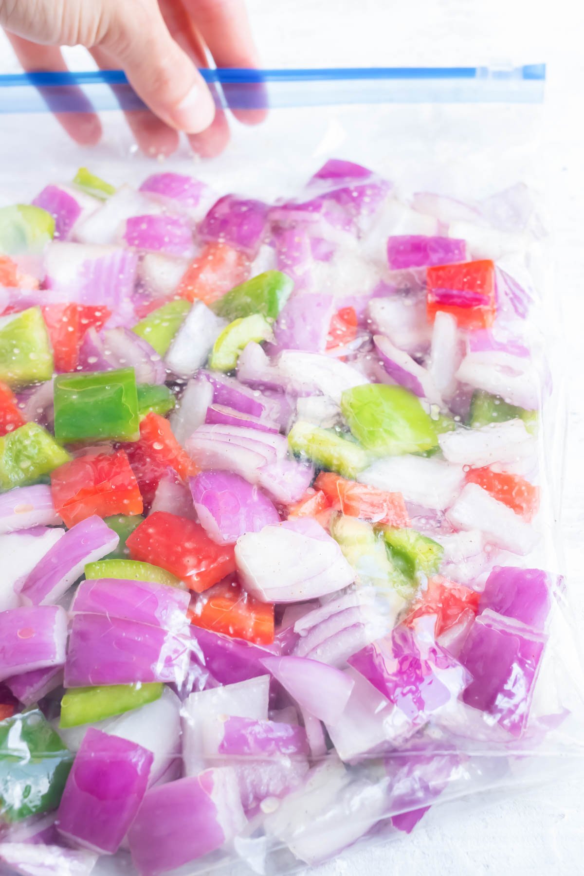 A bag is full of chopped veggies.