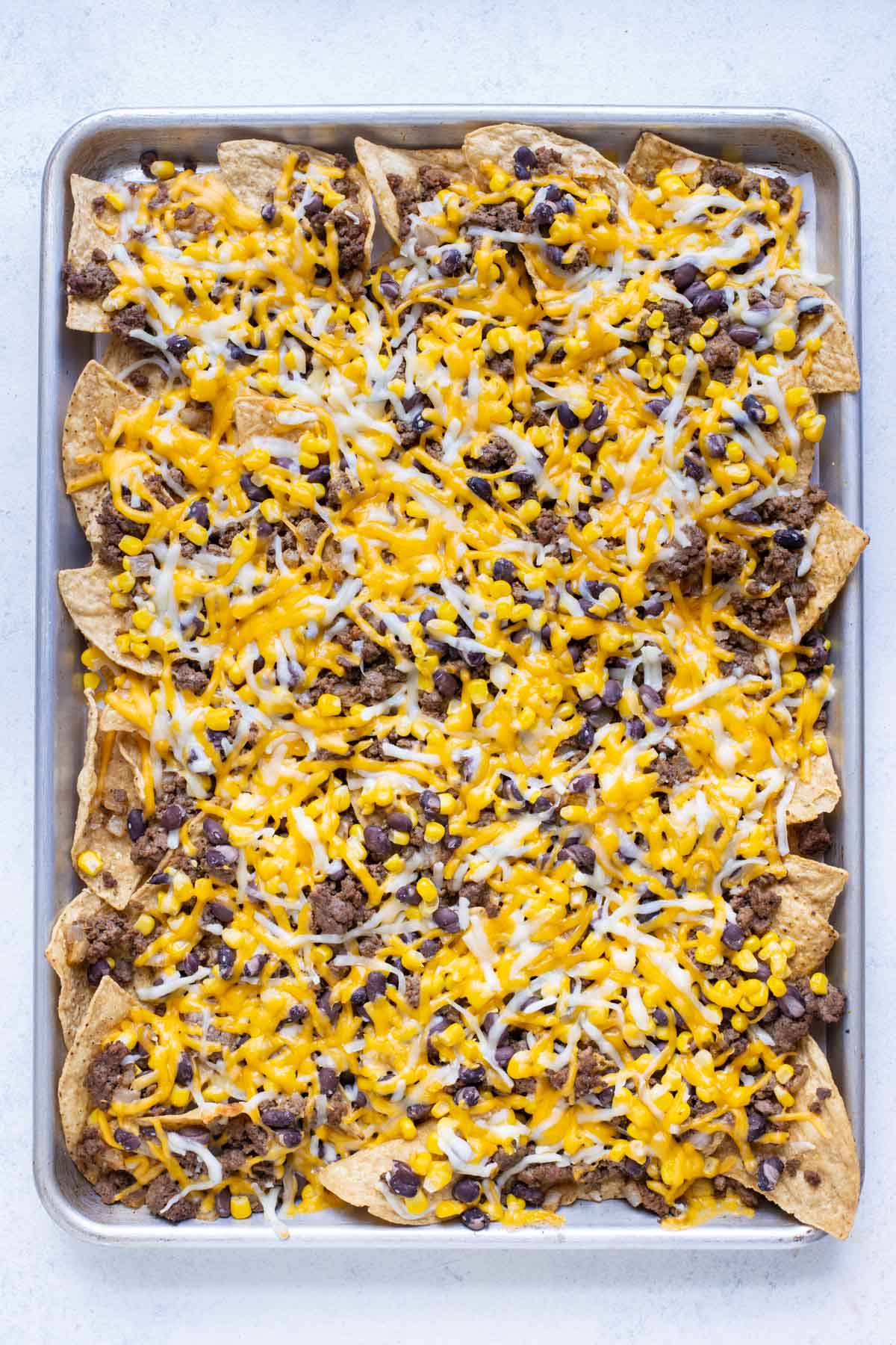 Perfectly baked sheet pan nachos just out of the oven.