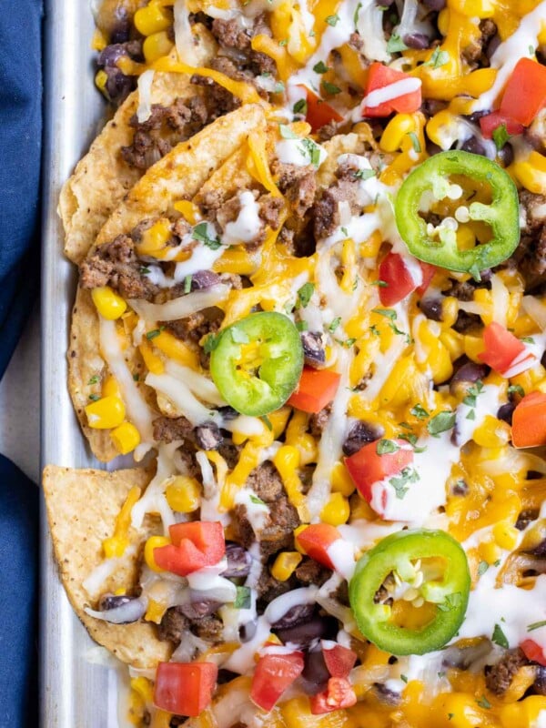 Top these loaded sheet pan nachos with jalapenos, sour cream, and pico.