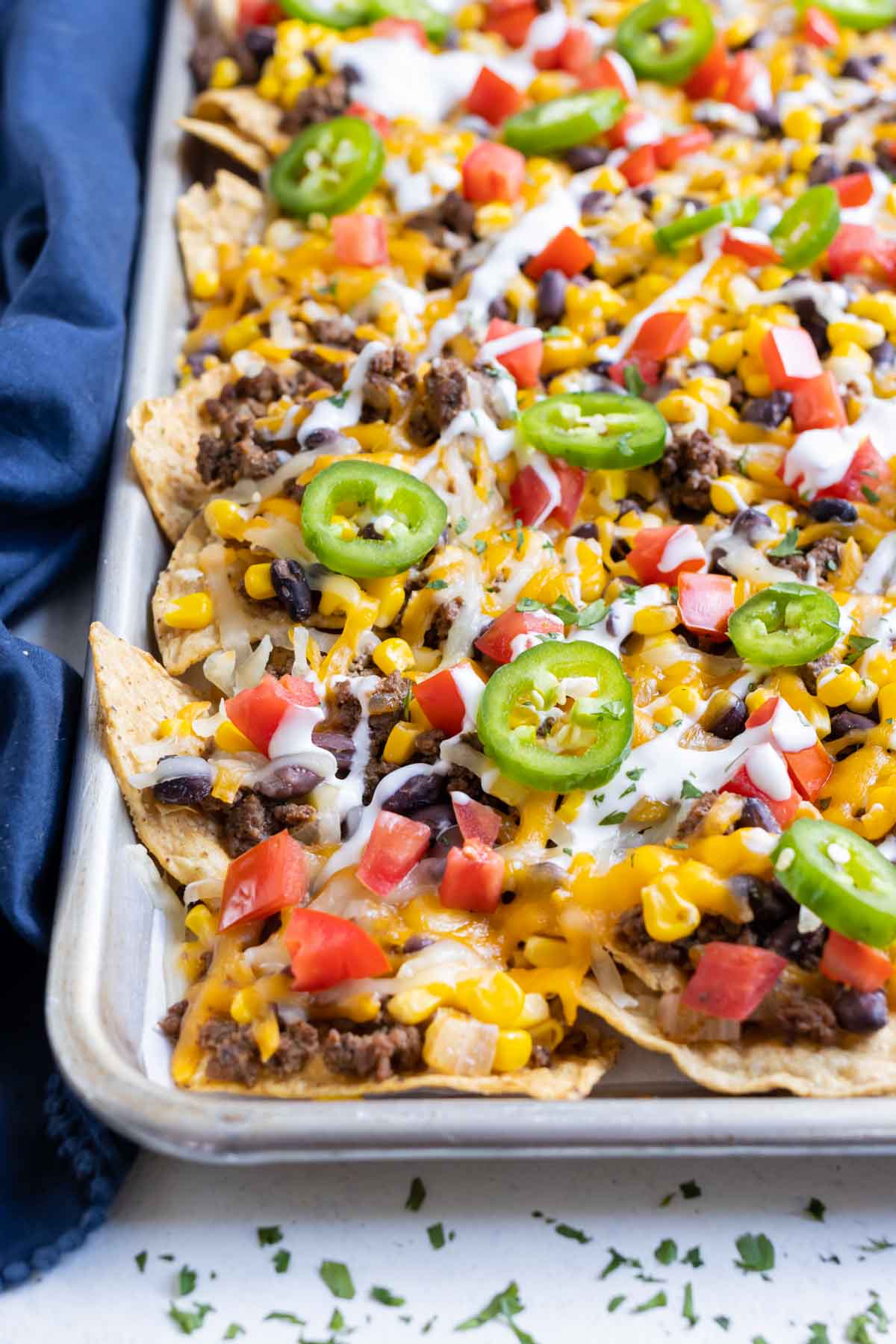 Top your nachos with your favorite toppings.