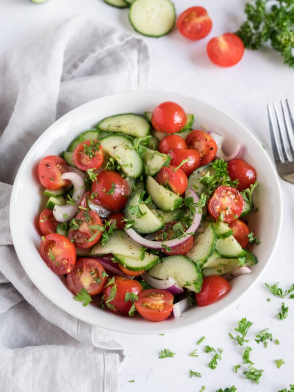 A bowl full of healthy cucumber tomato salad.