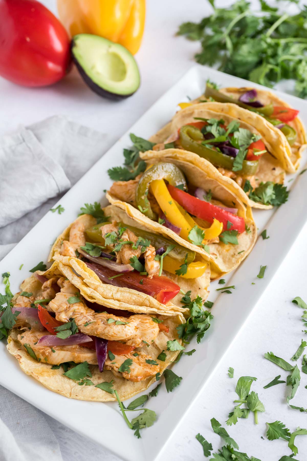 Oven fajitas with baked chicken and veggies in toasted corn tortillas.