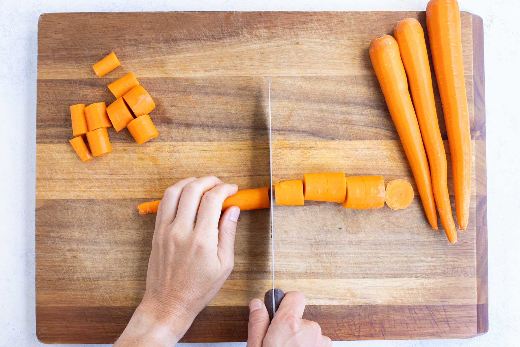 A carrot is sliced into 1-inch thick pieces.