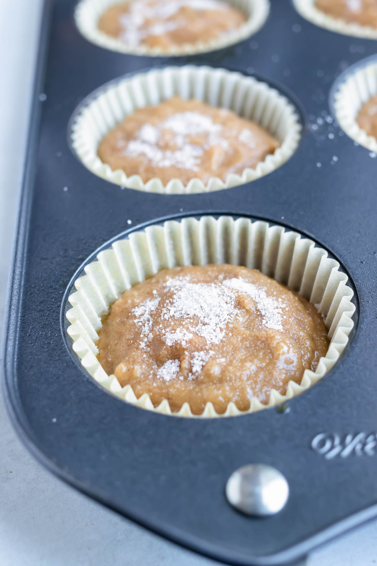 Fill muffin tins with applesauce muffin batter for a quick and easy breakfast.