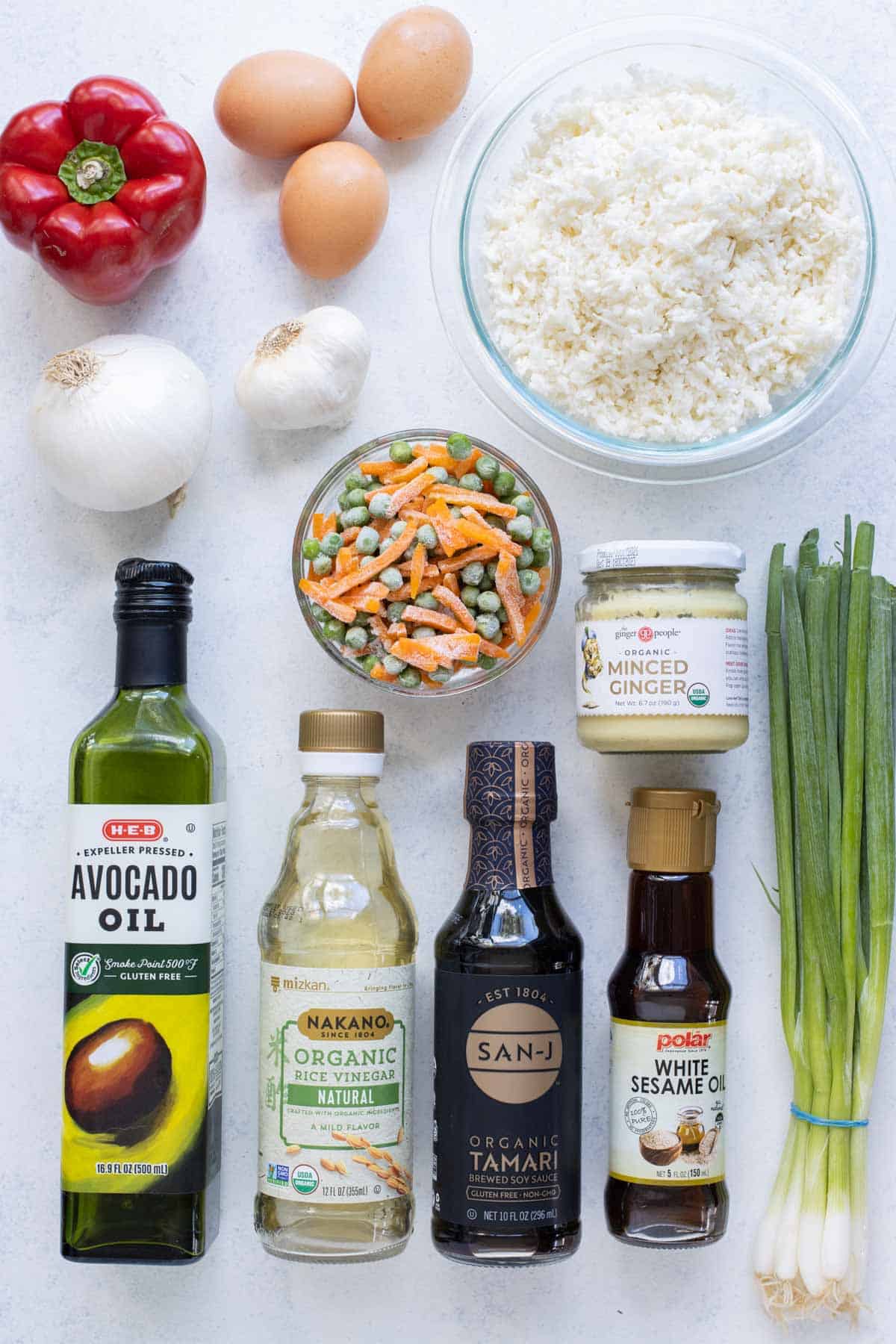 Riced cauliflower, eggs, vegetables, oils, and seasonings are the ingredients for cauliflower fried rice.