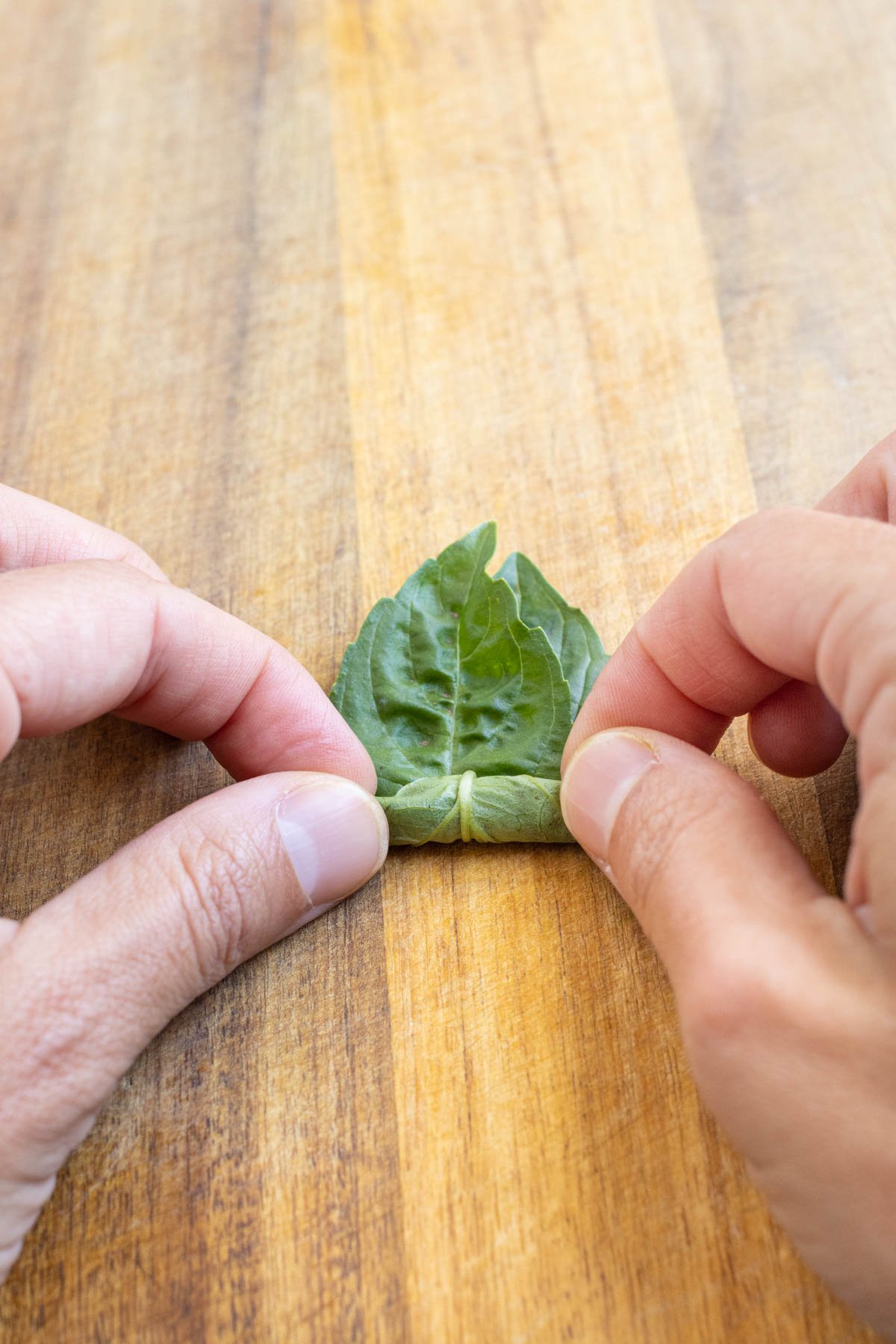 For long ribbons, roll basil from the stem end.