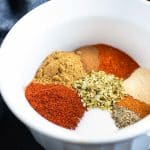 Spices in a white bowl showing how to make homemade chili seasoning.