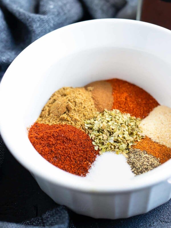 Spices in a white bowl showing how to make homemade chili seasoning.