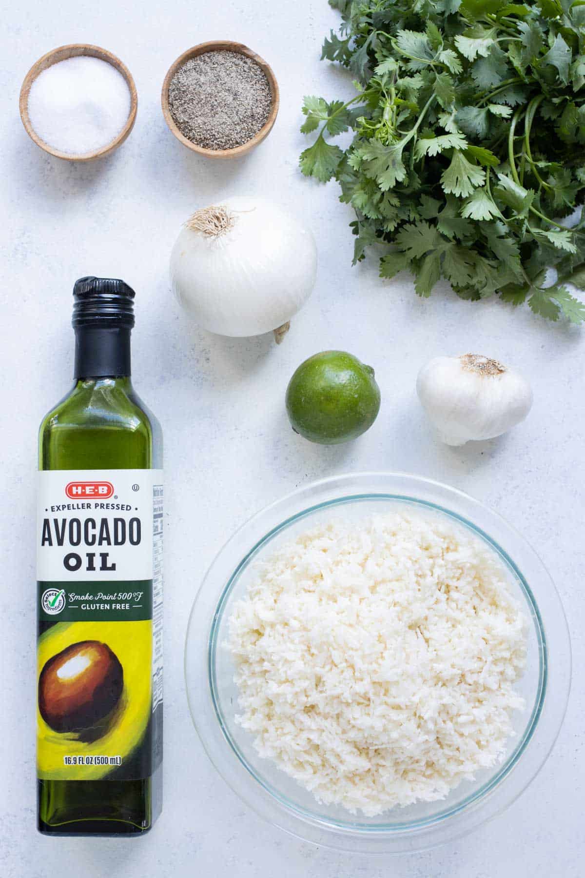Riced cauliflower, oil, onion, cilantro, lime, and garlic are the ingredients for this dish.