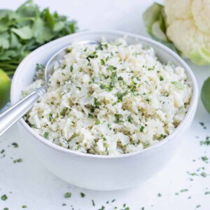 A bowl full of cilantro lime cauliflower rice is ready to enjoy.