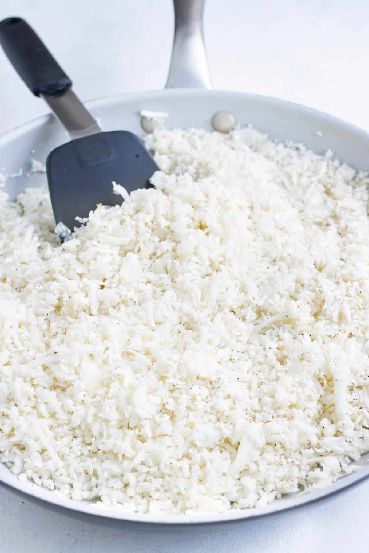 Riced cauliflower is added to the onion base.