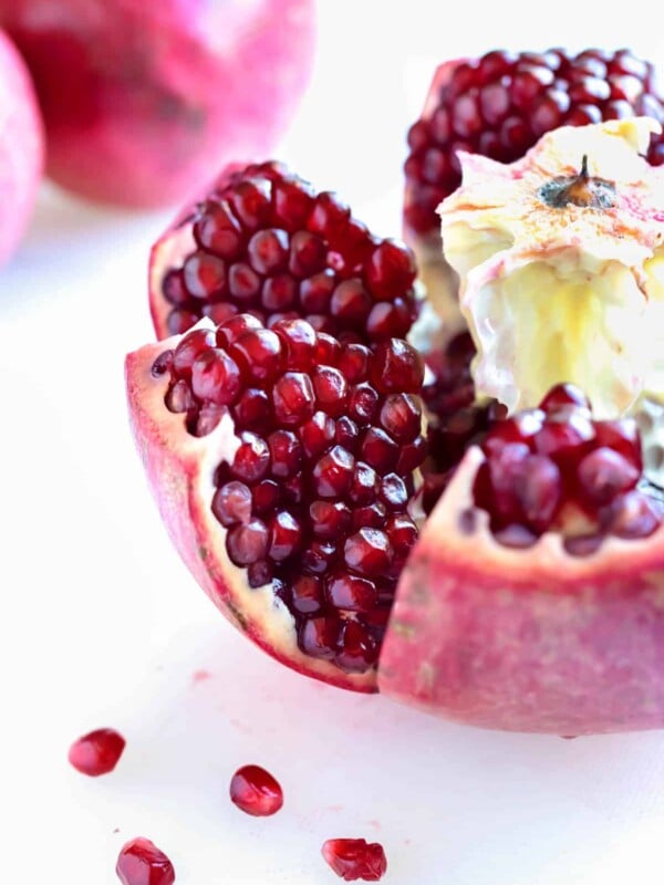 A whole pomegranate is cut open and the seeds exposed.