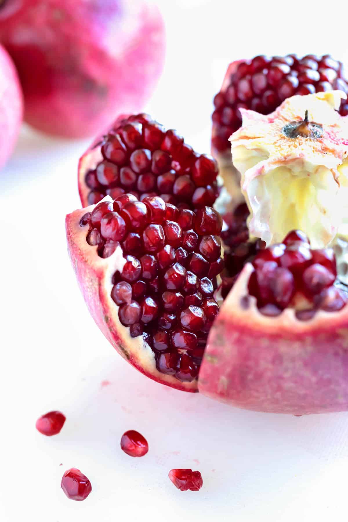 A whole pomegranate is cut open and the seeds exposed.