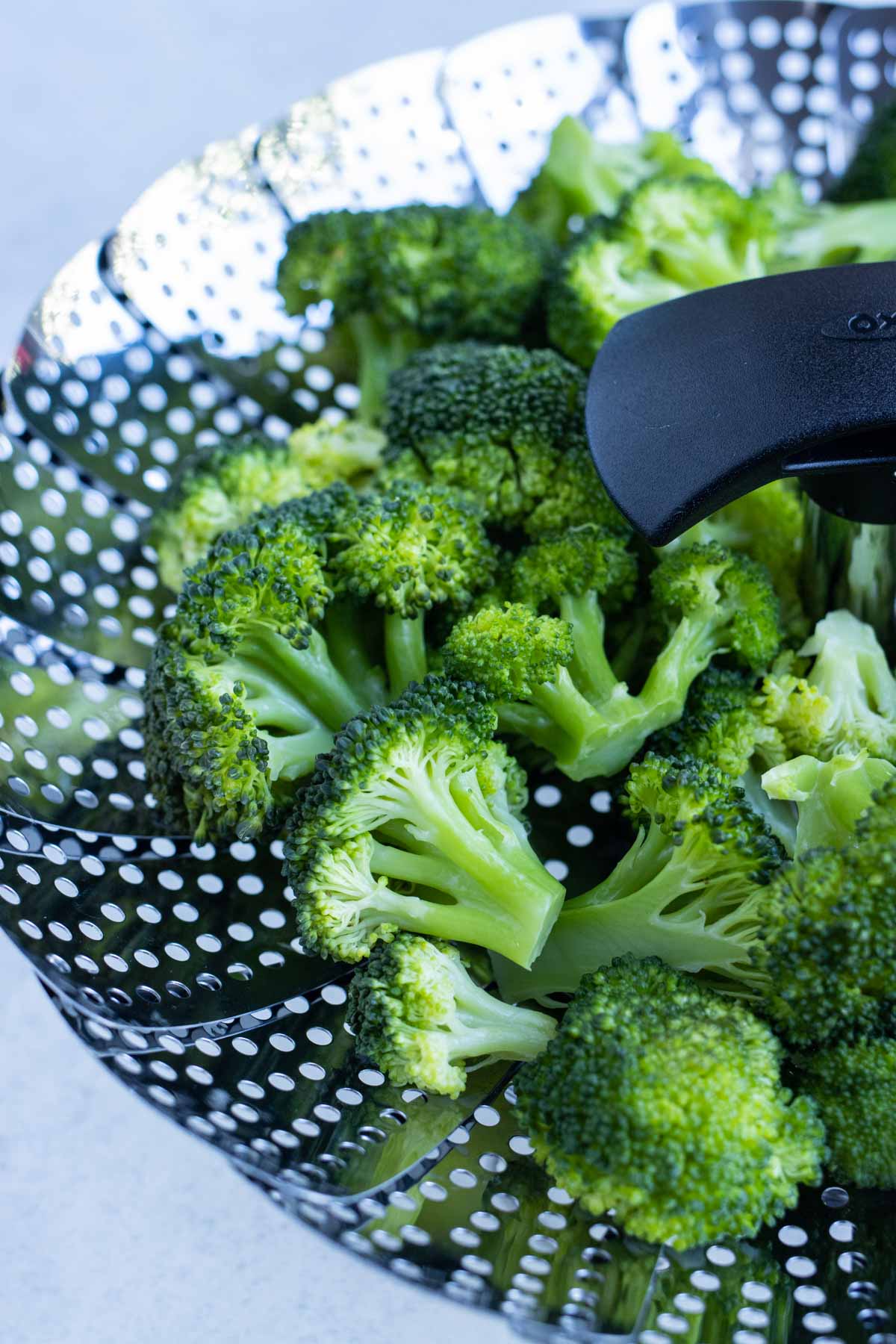 Healthy broccoli in a steamer basket is a healthy side dish.