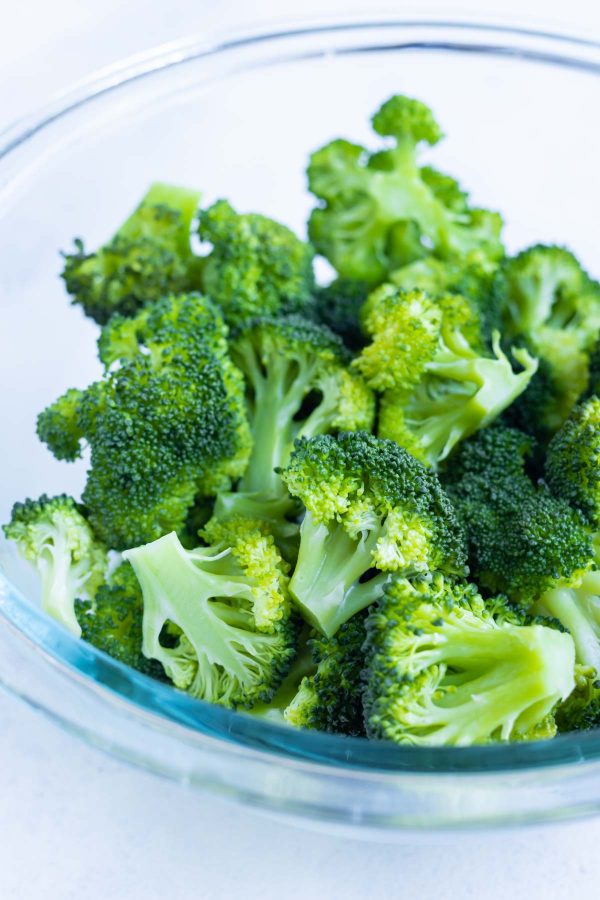 A bowl is full of steamed broccoli