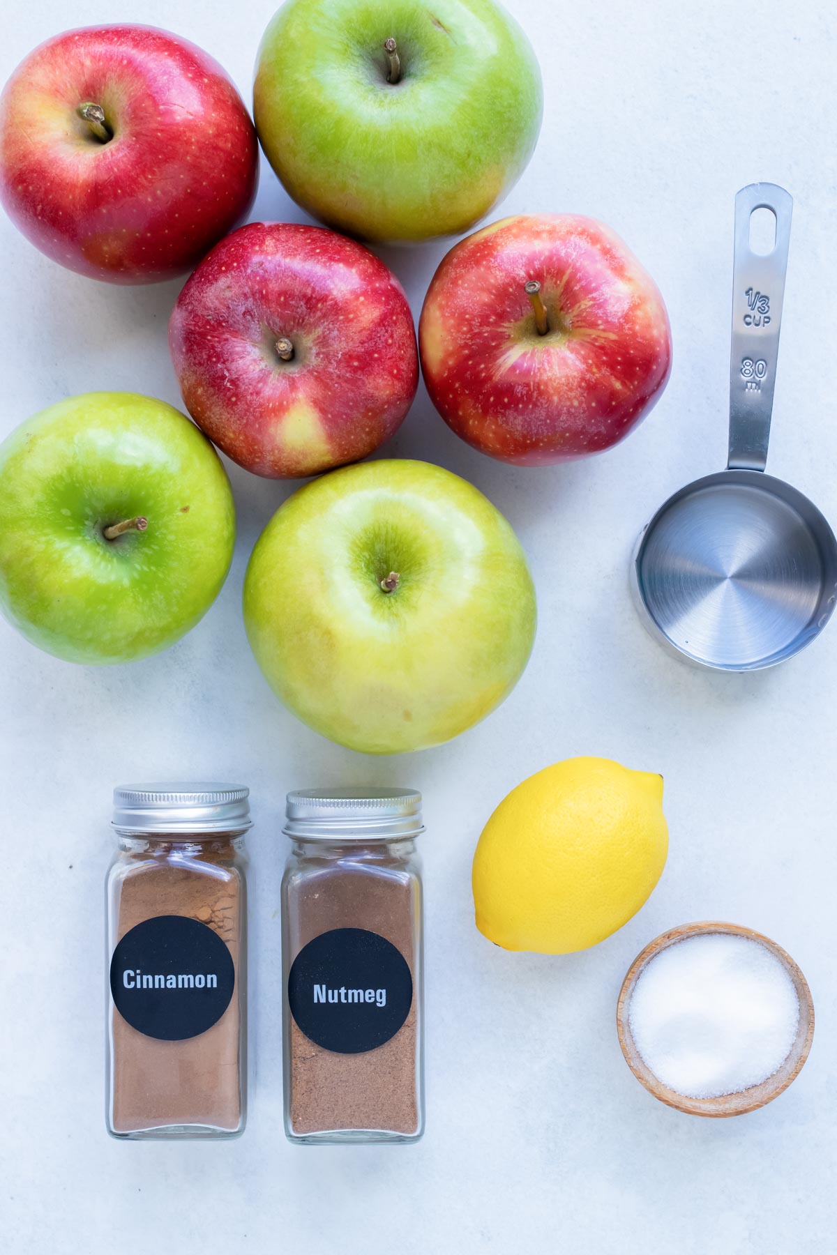 Apples, spices, lemon, and water are the ingredients needed for homemade Instant Pot Applesauce recipe.