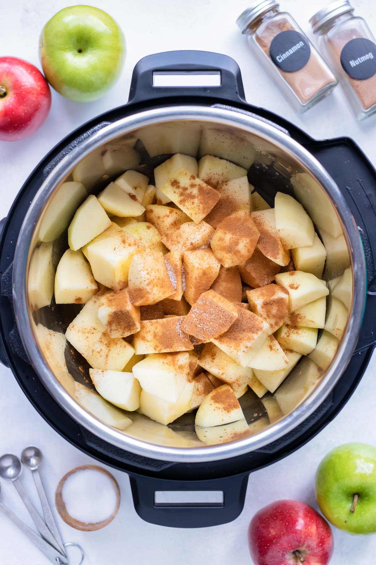 Cubed apples, spices, water, and lemon juice are added to the pressure cooker.