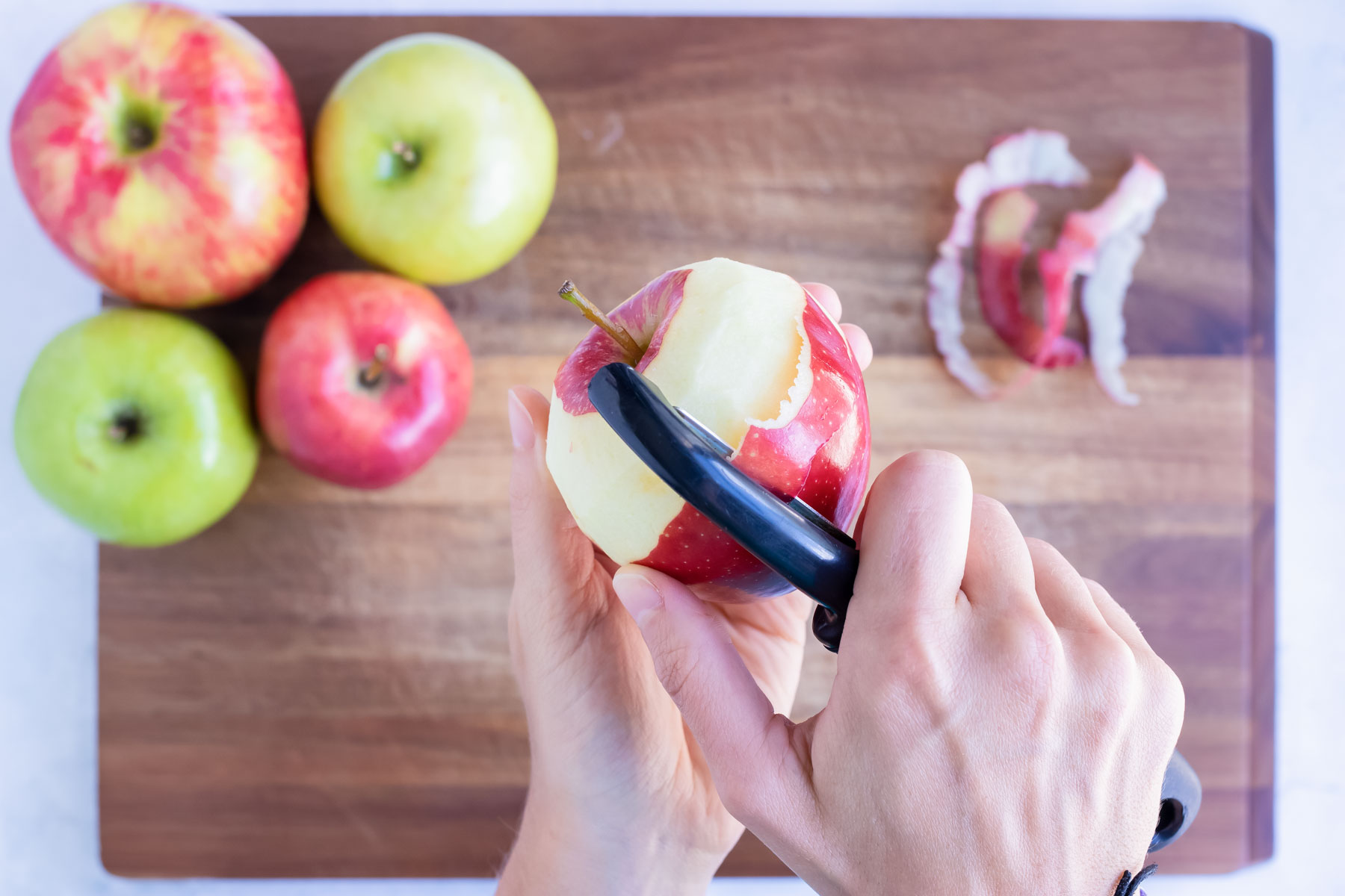 Use a vegetable peeler to peel apples before slicing for the best homemade applesauce.