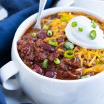 A white bowl full of chili is a healthy fall dish.