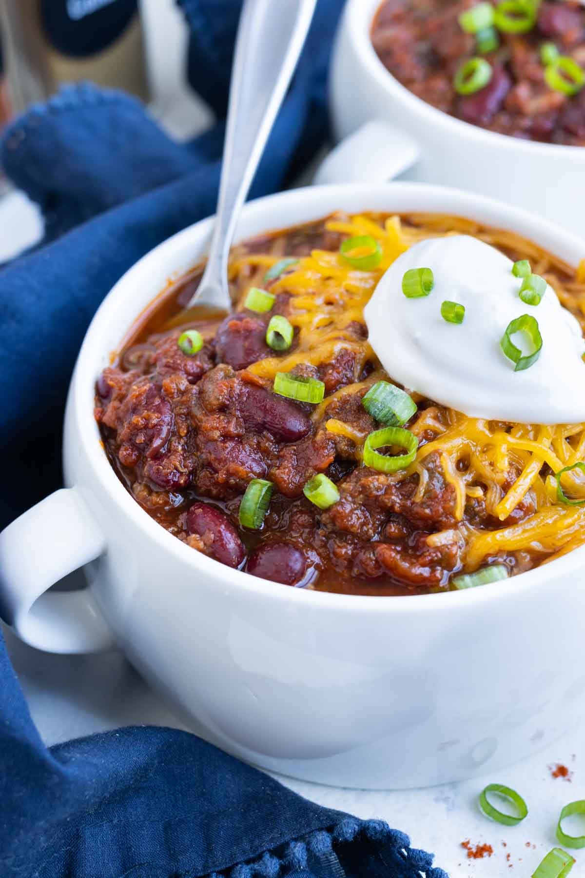 A white bowl full of chili is a healthy fall dish.