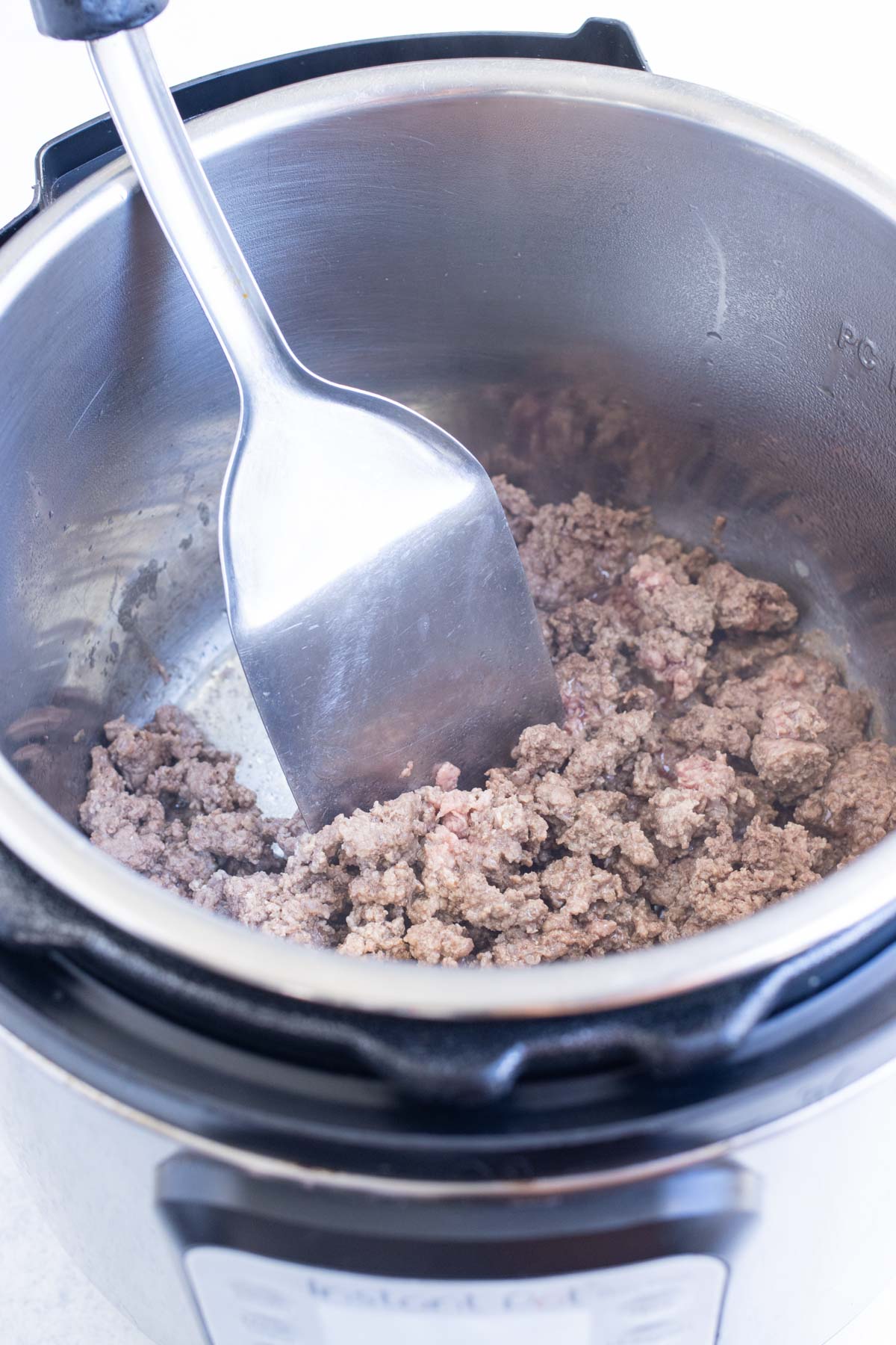 Ground beef is cooked in an Instant Pot.