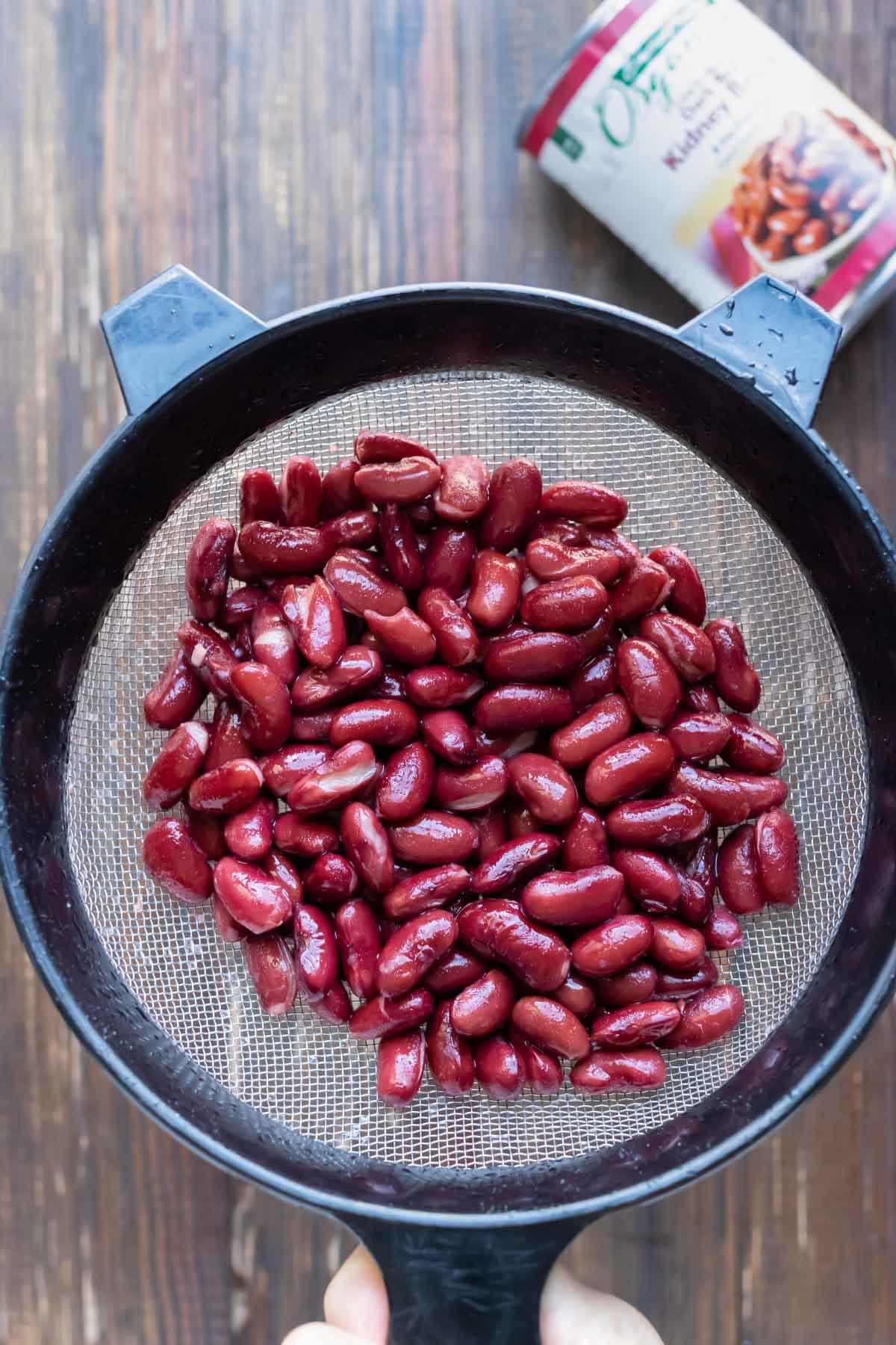 Dark red kidney beans rinsed and drained in a fine mesh strainer for turkey chili.