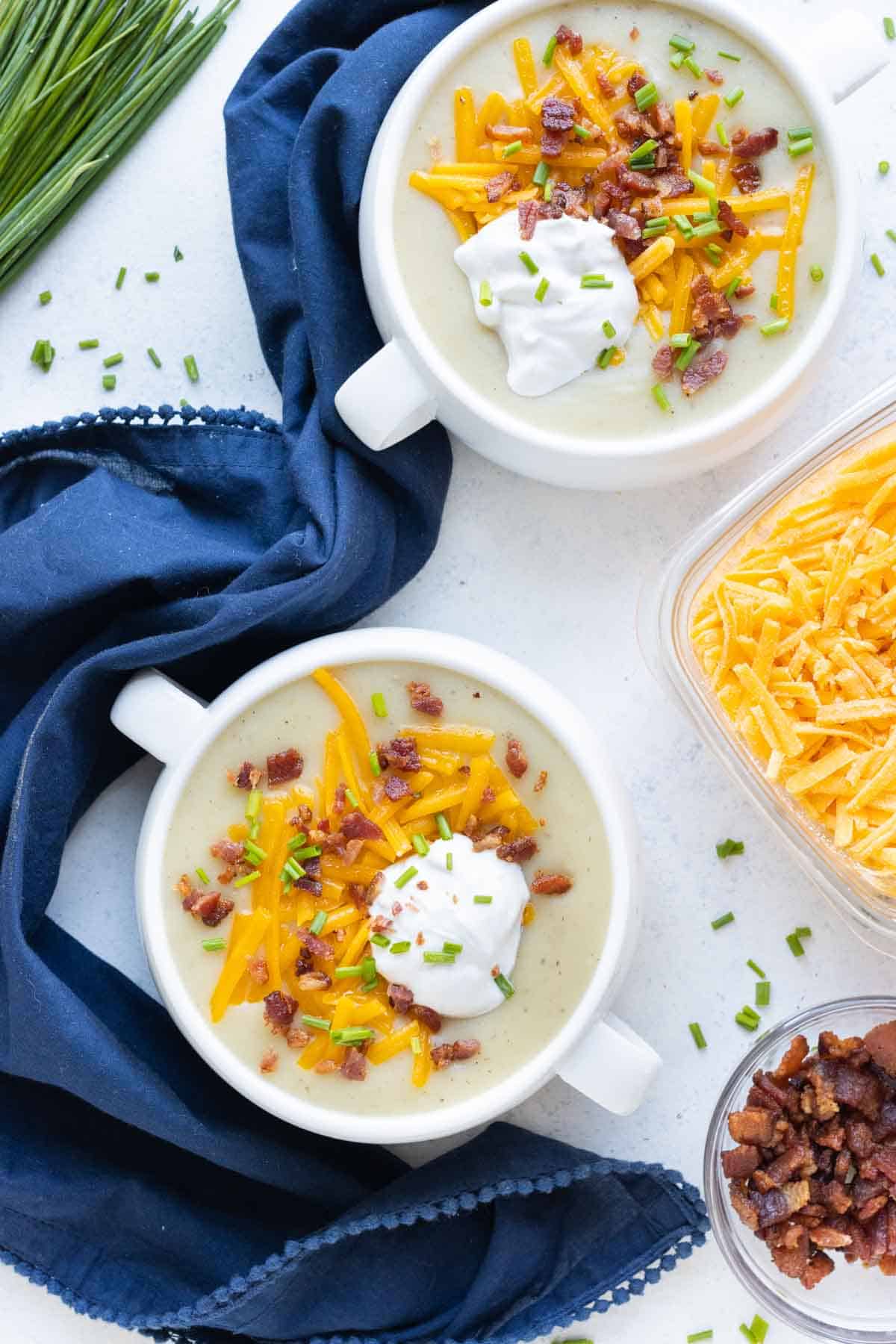Two white bowls with Instant Pot potato soup.