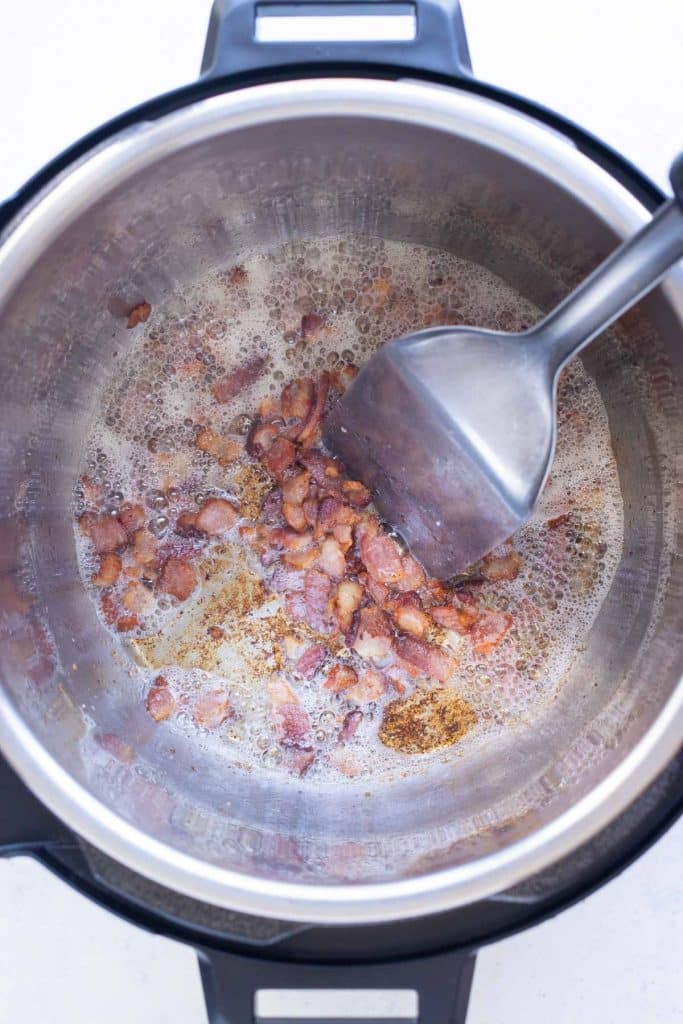 Chopped bacon crisping in an Instant Pot for easy potato soup.