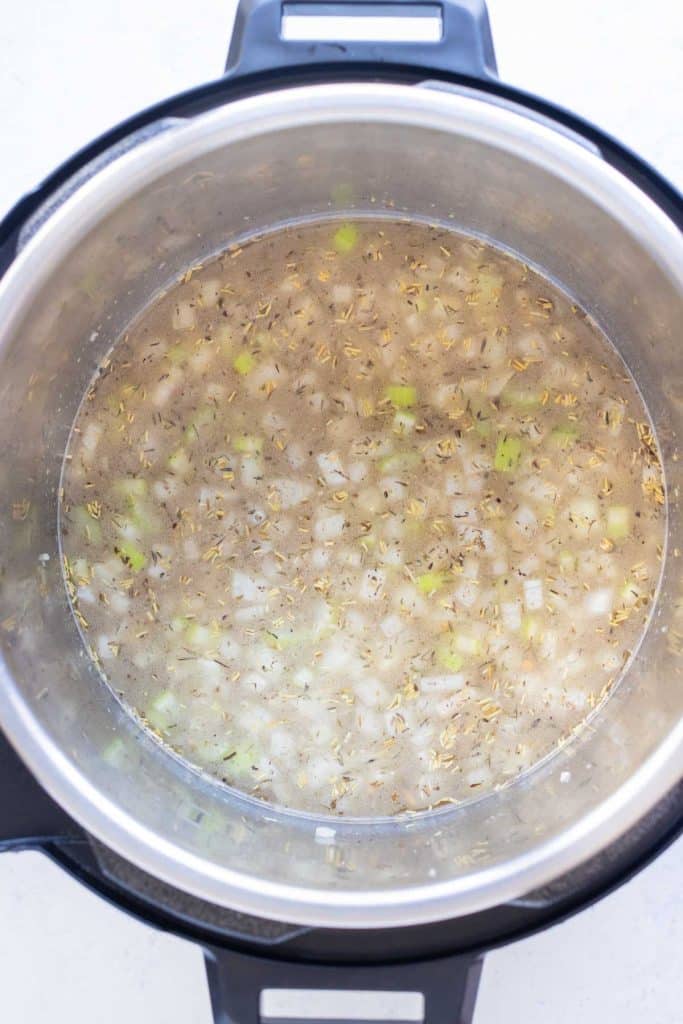 Onions and celery cooking in bacon fat to build the soup base.