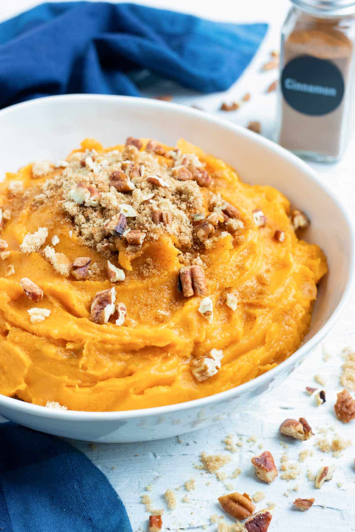 Easy and vegan mashed sweet potatoes recipe with brown sugar, cinnamon, and toasted pecans using Instant Pot potatoes.