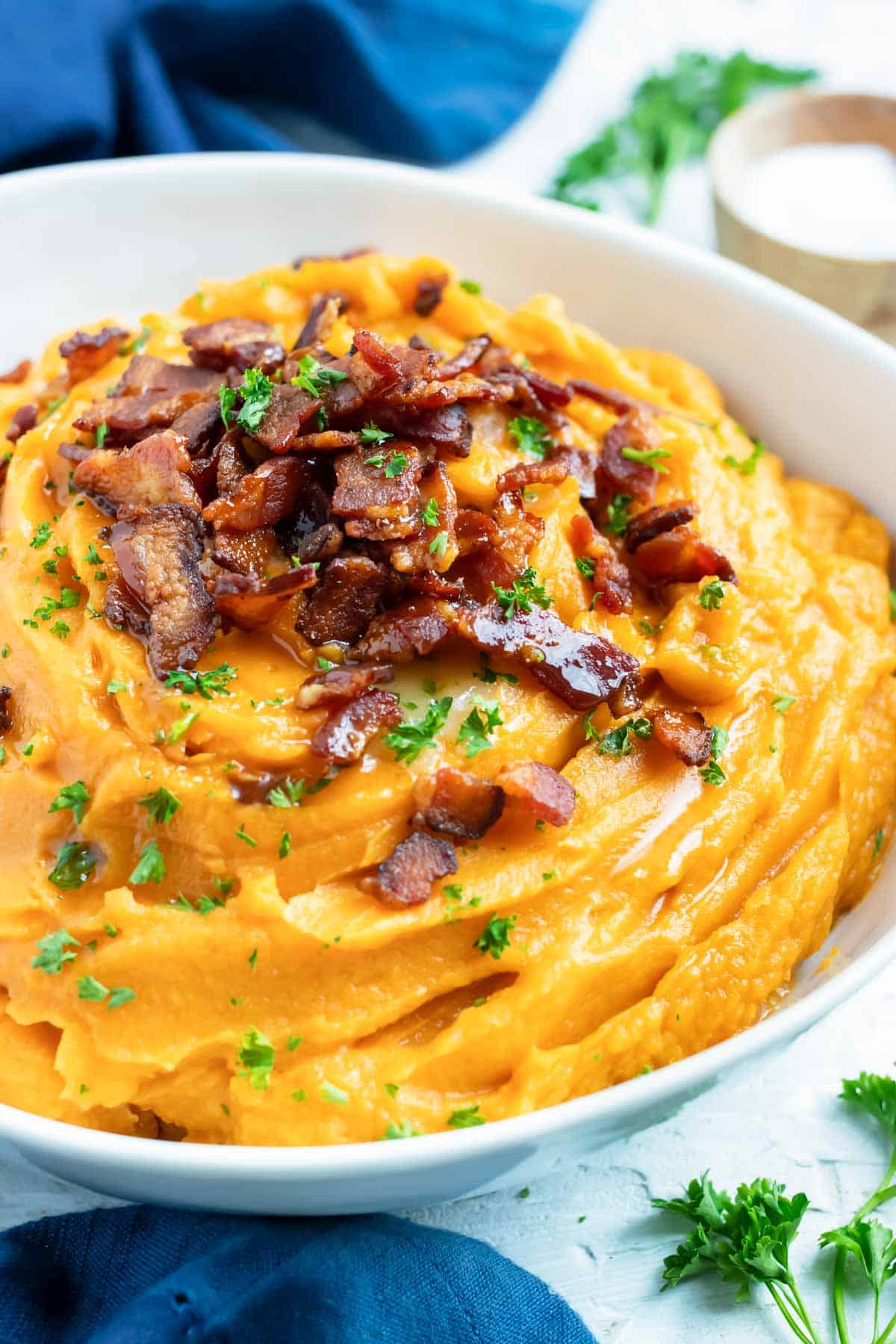 Bacon crumbled on top of a quick, easy, healthy side dish recipe for sweet potato mash.