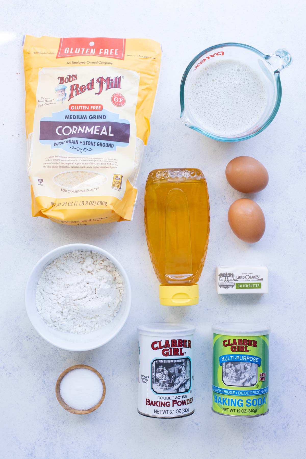Flour, cornmeal, honey, eggs, salt, and butter are the ingredients for cornbread muffins.