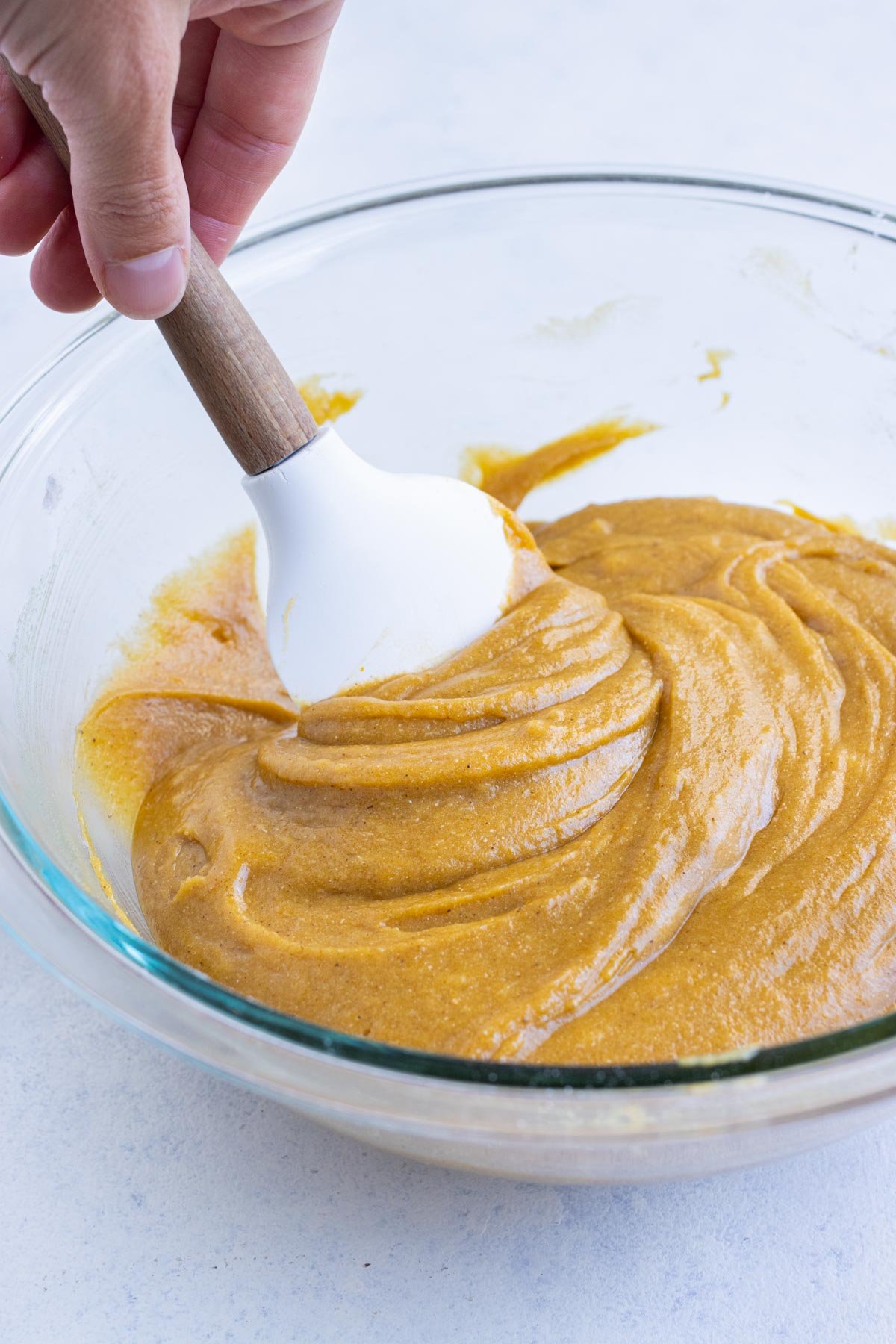 The wet and dry ingredients are mixed in a bowl.