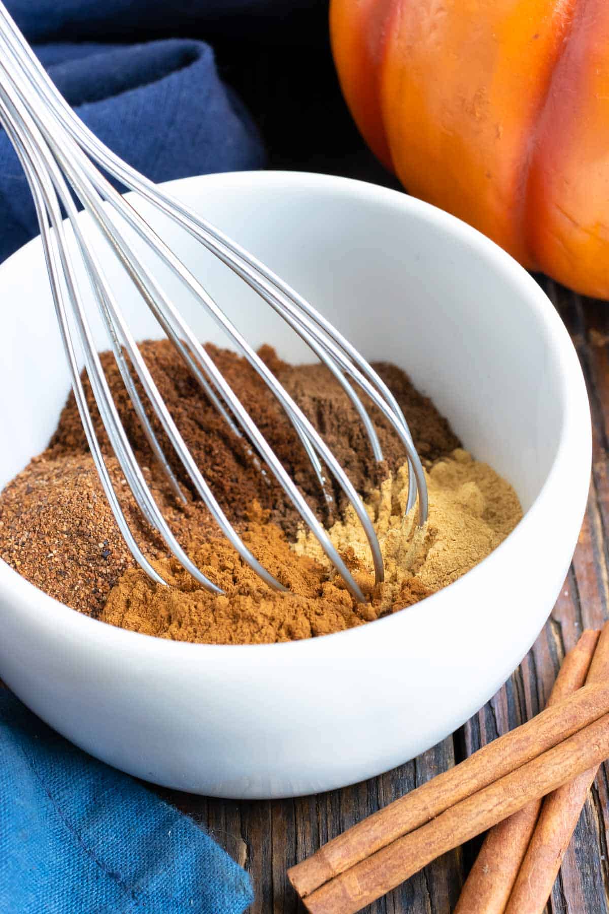 A whisk mixes the spices for the blend.