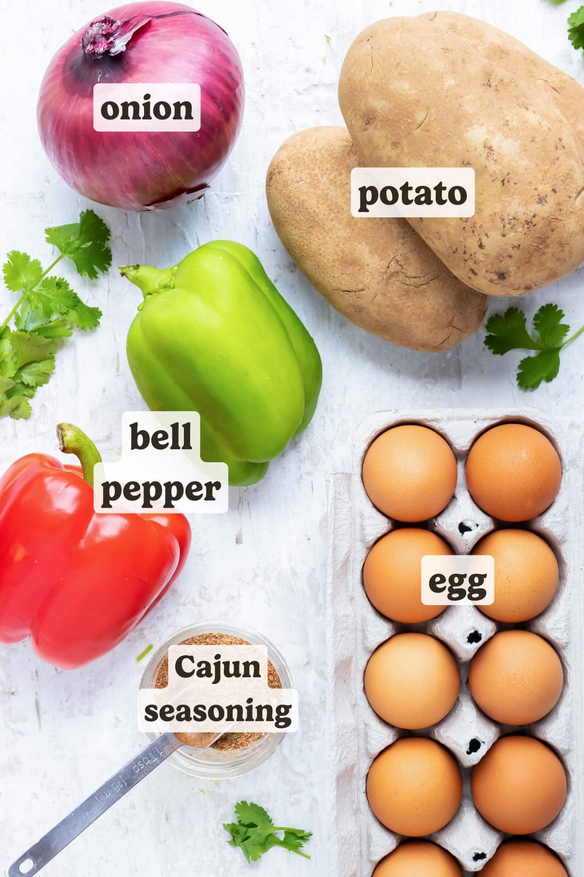Eggs, russet potatoes, bell peppers, onion, and blackened seasoning as the ingredients for a breakfast hash and eggs recipe.