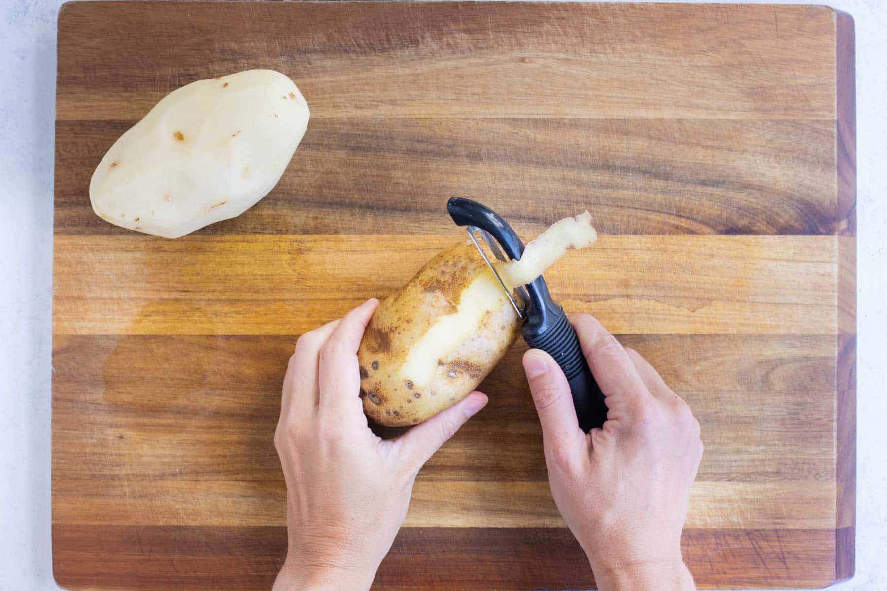 A potato is peeled to make mashed potatoes.